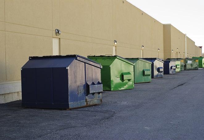 a red construction dumpster placed in front of a building under construction in Keosauqua